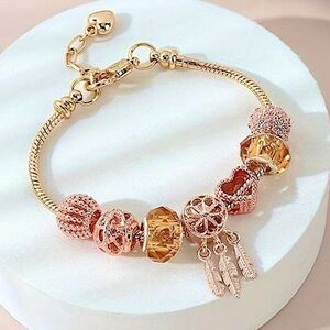 Chic Gold Tone Charm Bracelet Boho Feathers, Sparkle Crystal, and Ornate Beads